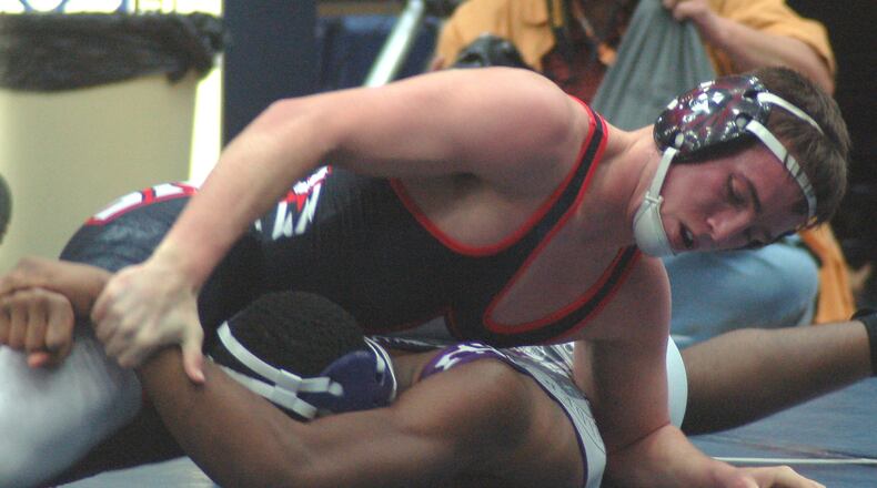 Fairfield’s Andrew Sams (top) tries to break the grip of Elder’s Charles Sanders during their 170-pound title match in the Division I district tournament at Fairmont’s Trent Arena on Saturday. Sams claimed a 15-5 win and his third title. CONTRIBUTED PHOTO BY JOHN CUMMINGS