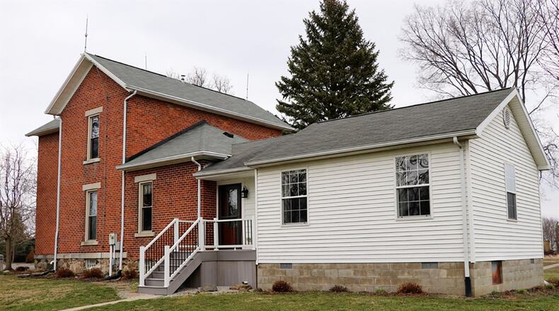 A hallway off the breakfast room leads to two full bathrooms and the first-floor main bedroom. The main bedroom was an addition to the original house and has a walk-in closet. Off the kitchen is the mudroom, which a door that leads to the composite deck.