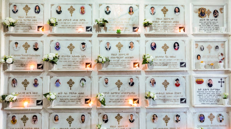 FILE - Candles are lit on a memorial wall during an anniversary service at the Holy Trinity Cathedral in Addis Ababa, Ethiopia, March 8, 2020, to remember those who died in the Ethiopian Airlines flight ET302 crash. (AP Photo/Mulugeta Ayene, File)