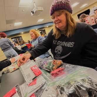Cindy Shivadecker puts together whistle kits during an assembly event hosted by Team Kettering on Friday, Jan. 26, 2026. SYDNEY DAWES/STAFF