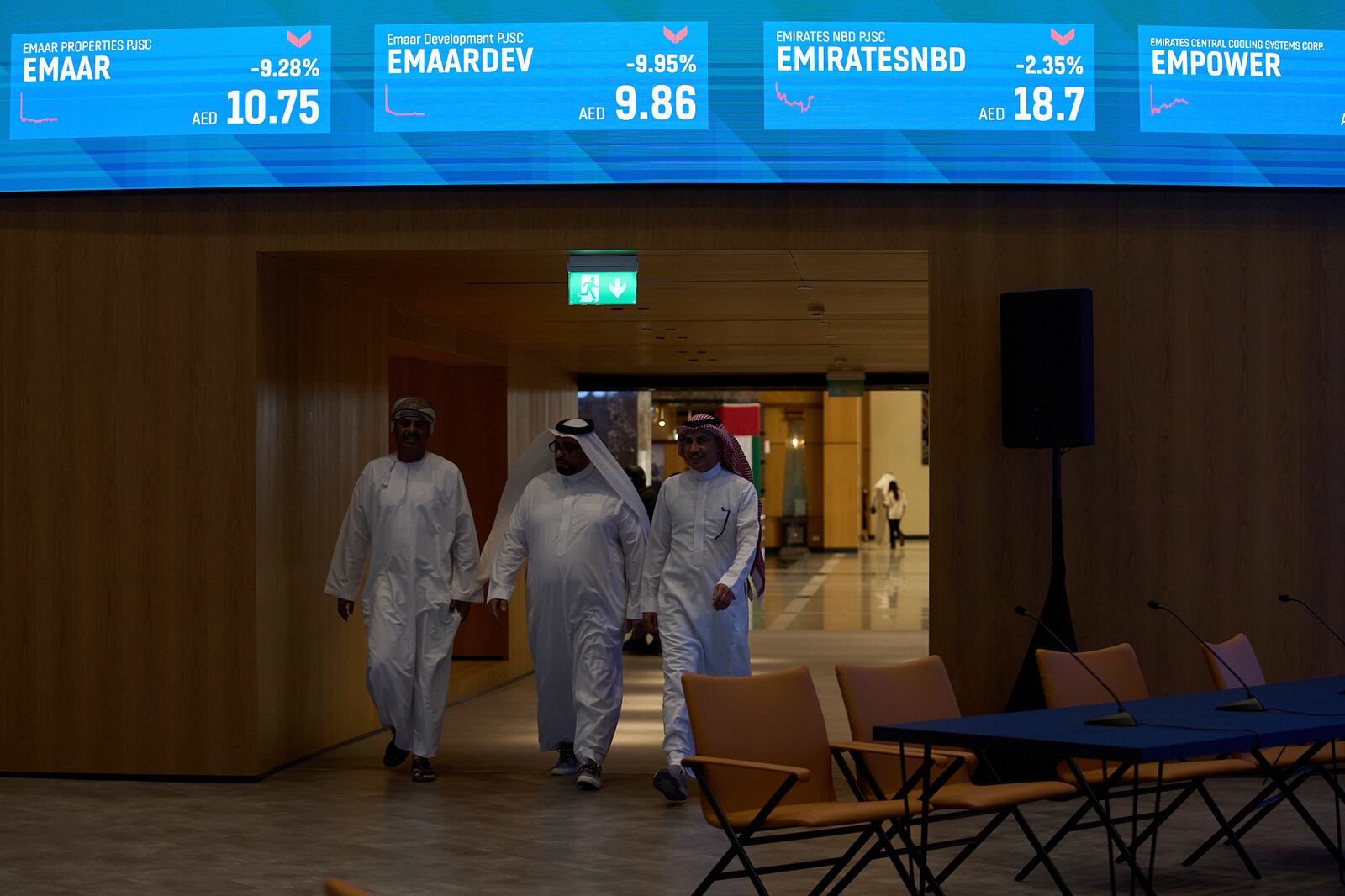 Emiratis are seen in the Dubai Financial Market in Dubai, United Arab Emirates, Monday, April 7, 2025. (AP Photos/Fatima Shbair)