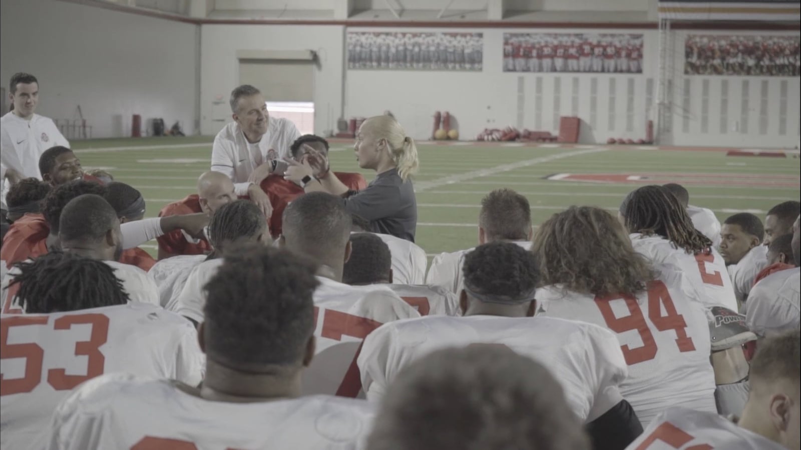 Ohio State trainer Ali Fischer addresses the team with Urban Meyer. CONTRIBUTED