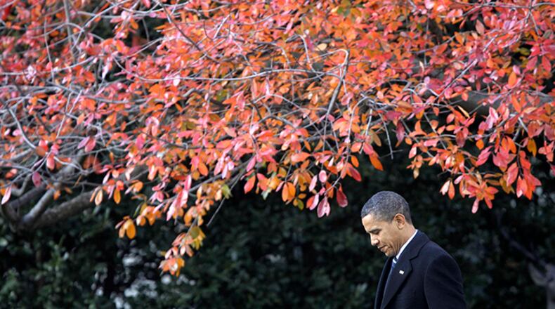 In this Dec. 6, 2010, file photo, President Barack Obama walks across the South Lawn of the White House in Washington, to board Marine One helicopter as he travels to Winston-Salem, N.C. More than half of Americans view President Barack Obama favorably as he leaves office, a new poll shows, but Americans remain deeply divided over his legacy. Less than half of Americans say they're better off eight years after his election or that Obama brought the country together.