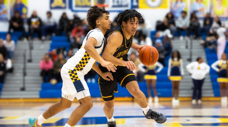 Centerville junior Trey Sam drives past Springfield senior Charles Cunningham during their Greater Western Ohio Conference game on Tuesday, Feb. 3, 2026. The Elks won 56-44. MICHAEL COOPER / STAFF