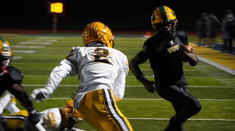 Alter’s John Keighley (2) looks to make a tackle on Taft's Monsanna Torbert (1) on Friday night at Monroe Hornet Stadium. Chris Vogt/CONTRIBUTED