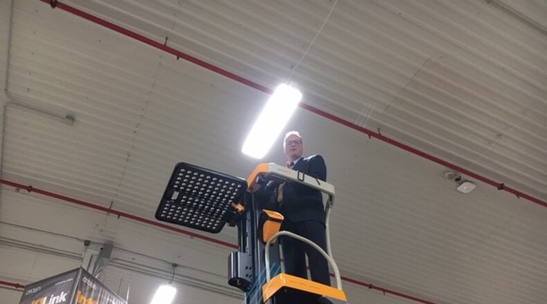 A Crown Equipment staff member demonstrates one of Crown’s lift trucks. THOMAS GNAU/STAFF