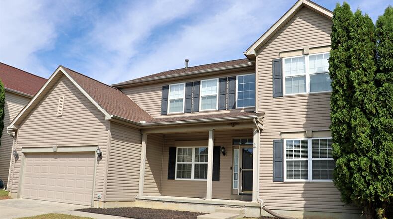 This Dayton property is on the market for $439,998. The interior of this two-story home has been renovated with neutral colors, wood-plank flooring and beautiful light fixtures. Contributed photos by Kathy Tyler