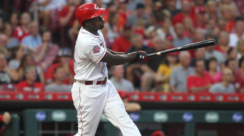 The Reds’ Aristides Aquino hits a home run against the Angels on Tuesday, Aug. 6, 2019, at Great American Ball Park in Cincinnati. David Jablonski/Staff