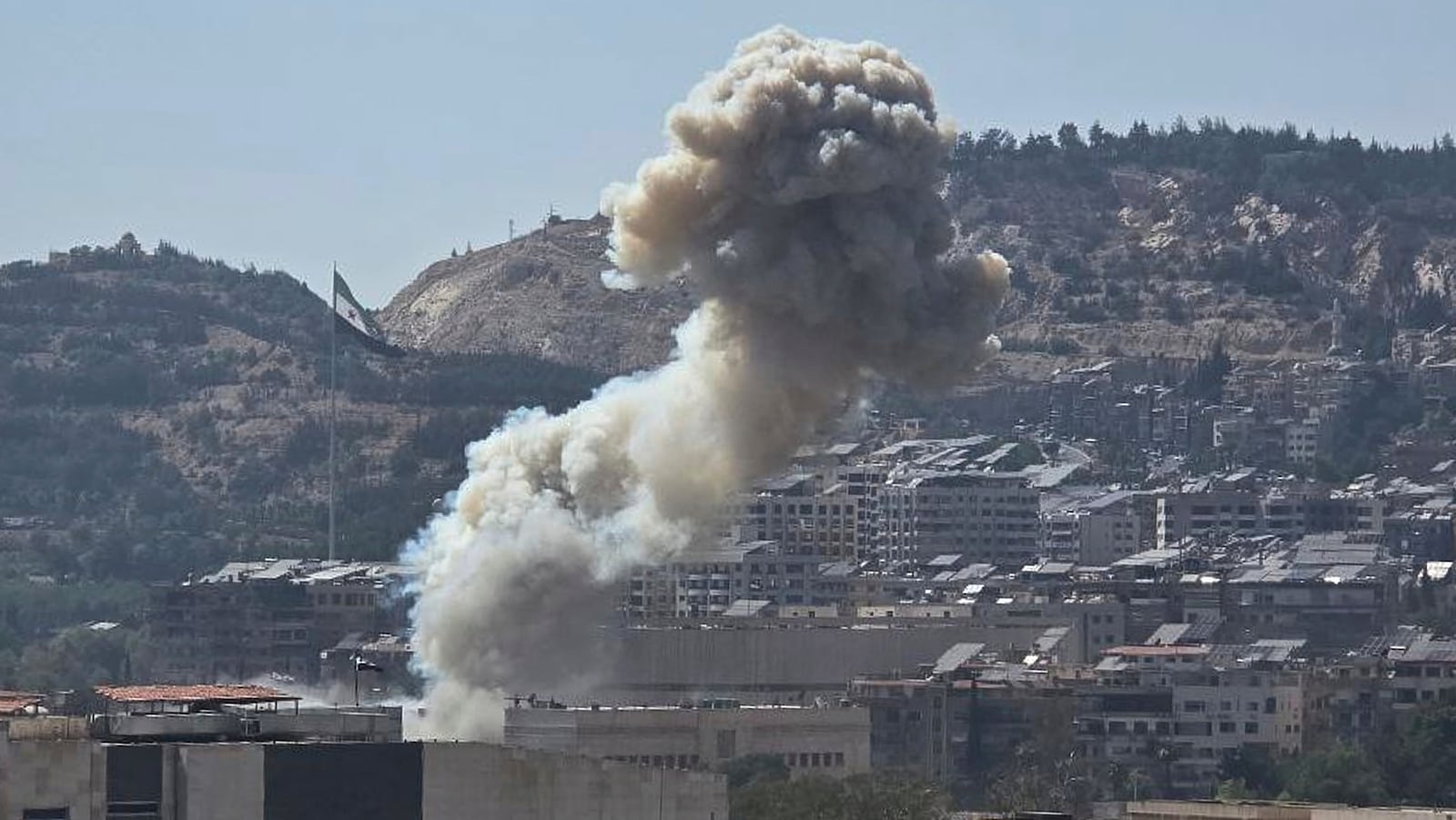 In this photo released by the Syrian official news agency SANA, smoke rises from an Israeli airstrike that hit the Syrian Defence Ministry, in Damascus, Syria, Wednesday, July 16, 2025. (SANA via AP)