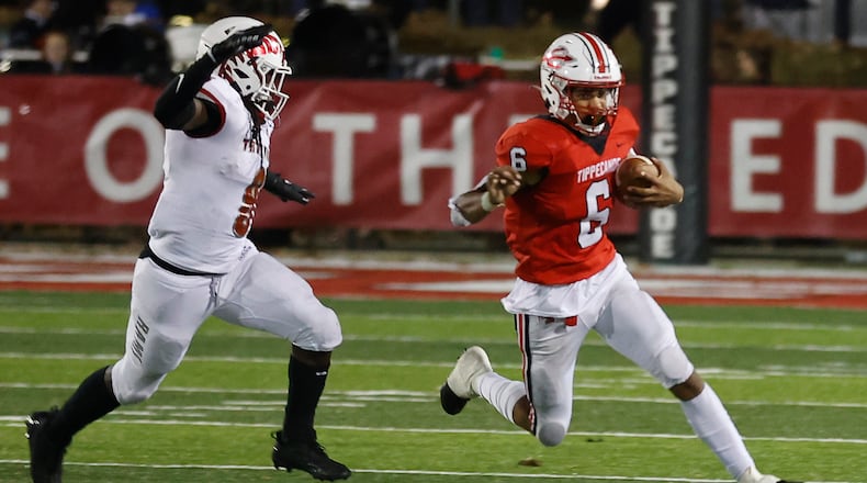 Tipp's Xavier Jones (right) scored a pair of second-half touchdowns in Friday's playoff win over Western Brown. BILL LACKEY/STAFF FILE PHOTO