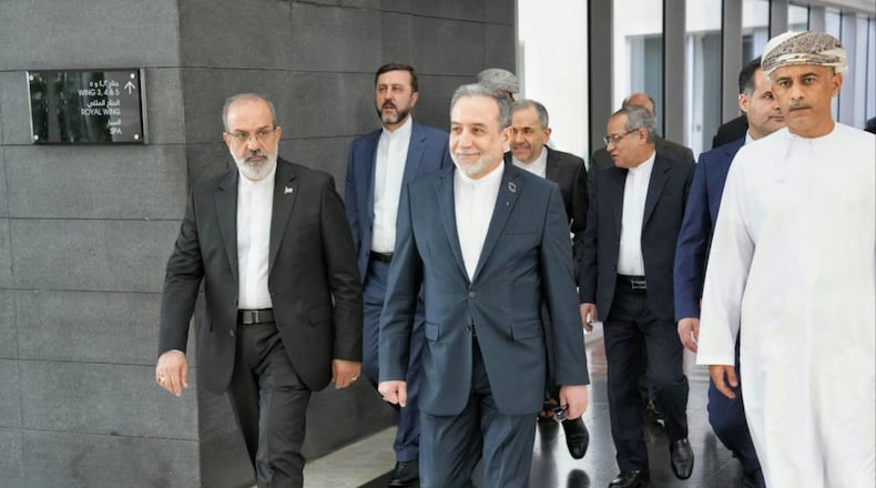 In this photo released by the Iranian Foreign Ministry, Iranian Foreign Minister Abbas Araghchi, center, heads to venue for talks between Iran and the U.S., in Muscat, Oman, Friday, Feb. 6, 2026. (Iranian Foreign Ministry via AP)