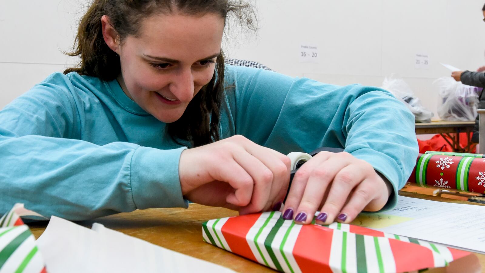 Miami University Sophomore Delayna Shulak wraps gifts for the Miami Holiday Project Tuesday, Dec 13 in Phillips Hall in Oxford. The Miami Holiday Project is a local service project that accepts donations for holiday gifts for children in foster care in Butler and Preble counties. Student and staff volunteers from Miami University wrap the gifts that are then delivered to agencies who deliver the gifts to the children. The program has been active for over twenty years. "I love wrapping presents and I love community service so it checked both boxes for me," Shulak said. NICK GRAHAM/STAFF
