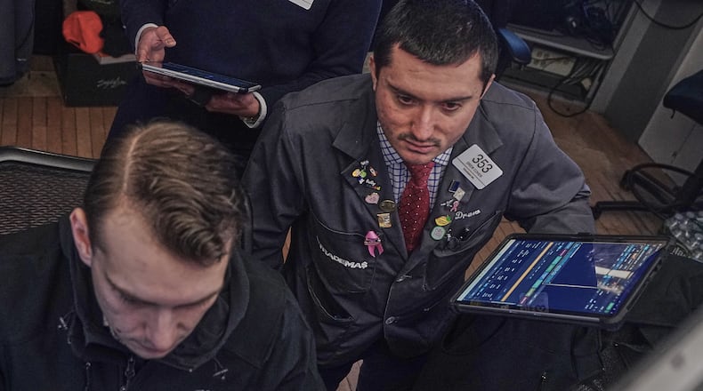Traders Dylan Halvorsan, left, and Drew Cohen work on the floor of the New York Stock Exchange, Friday, Feb. 13, 2026, in New York. (AP Photo/Richard Drew)