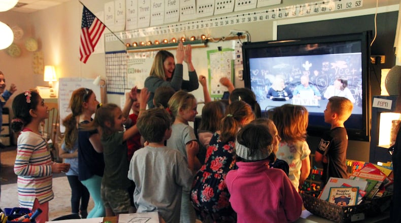 Primary Village North teacher Kelsey Hebeler celebrates with her first grade students after learning PVN was named a 2019 National School of Character.