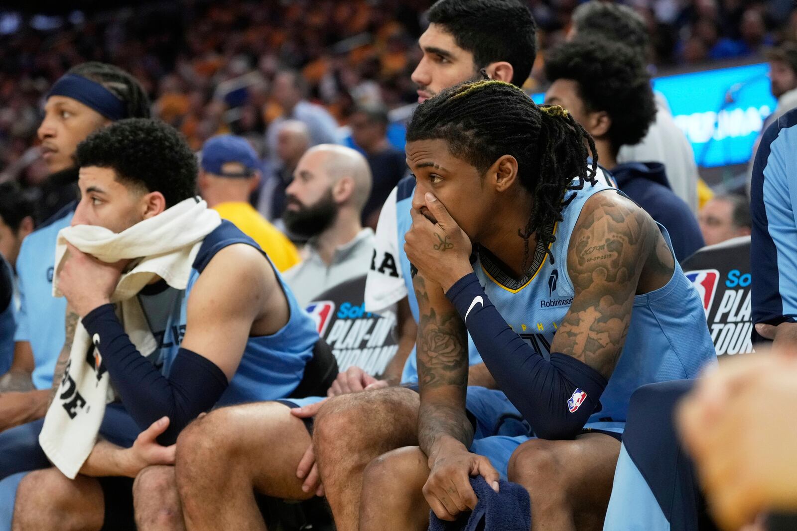Memphis Grizzlies guard Ja Morant, right, reacts from the bench during the second half of an NBA play-in tournament basketball game against the Golden State Warriors in San Francisco, Tuesday, April 15, 2025. (AP Photo/Jeff Chiu)