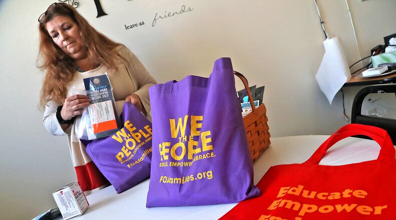 Trish Williams-Chase pauses as she places Narcan in one of the "GO Bags" Thursday, Oct. 13, 2022 at the Family of Addicts office in Springfield. BILL LACKEY/STAFF