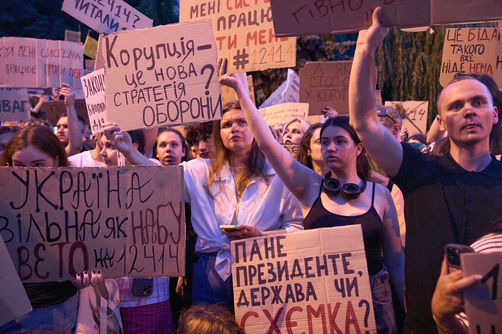 Participants hold banners during a protest against a law targeting anti-corruption institutions in central Kyiv, Ukraine, Wednesday, July 23, 2025. (AP Photo/Efrem Lukatsky)