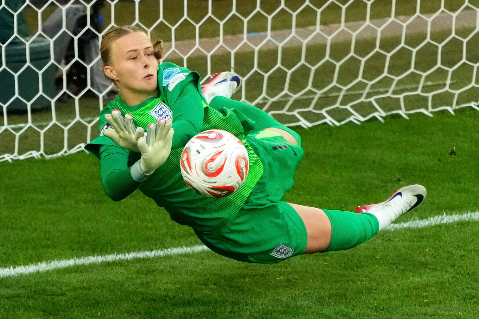 England goalkeeper Hannah Hampton stops a shot from Spain's Aitana Bonmati during a penalty shootout at the end of the Women's Euro 2025 final soccer match between England and Spain at St. Jakob-Park in Basel, Switzerland, Sunday, July 27, 2025. (AP Photo/Michael Probst)