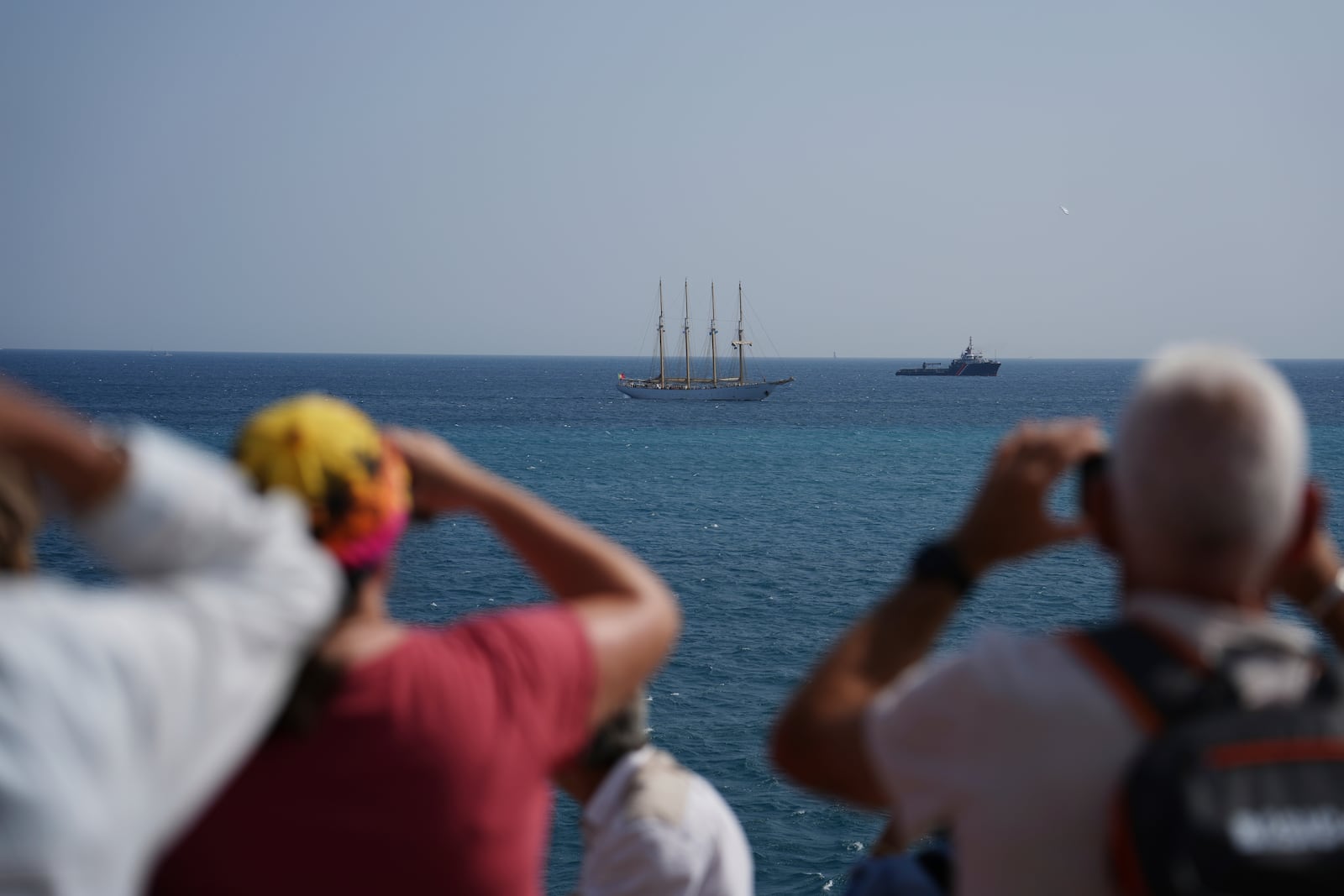 People take photos of vessels during the "Ocean Wonders" event in honor of World Oceans Day ahead of the U.N. Ocean Conference on Sunday, June 8, 2025, in Nice, France. (AP Photo/Annika Hammerschlag)