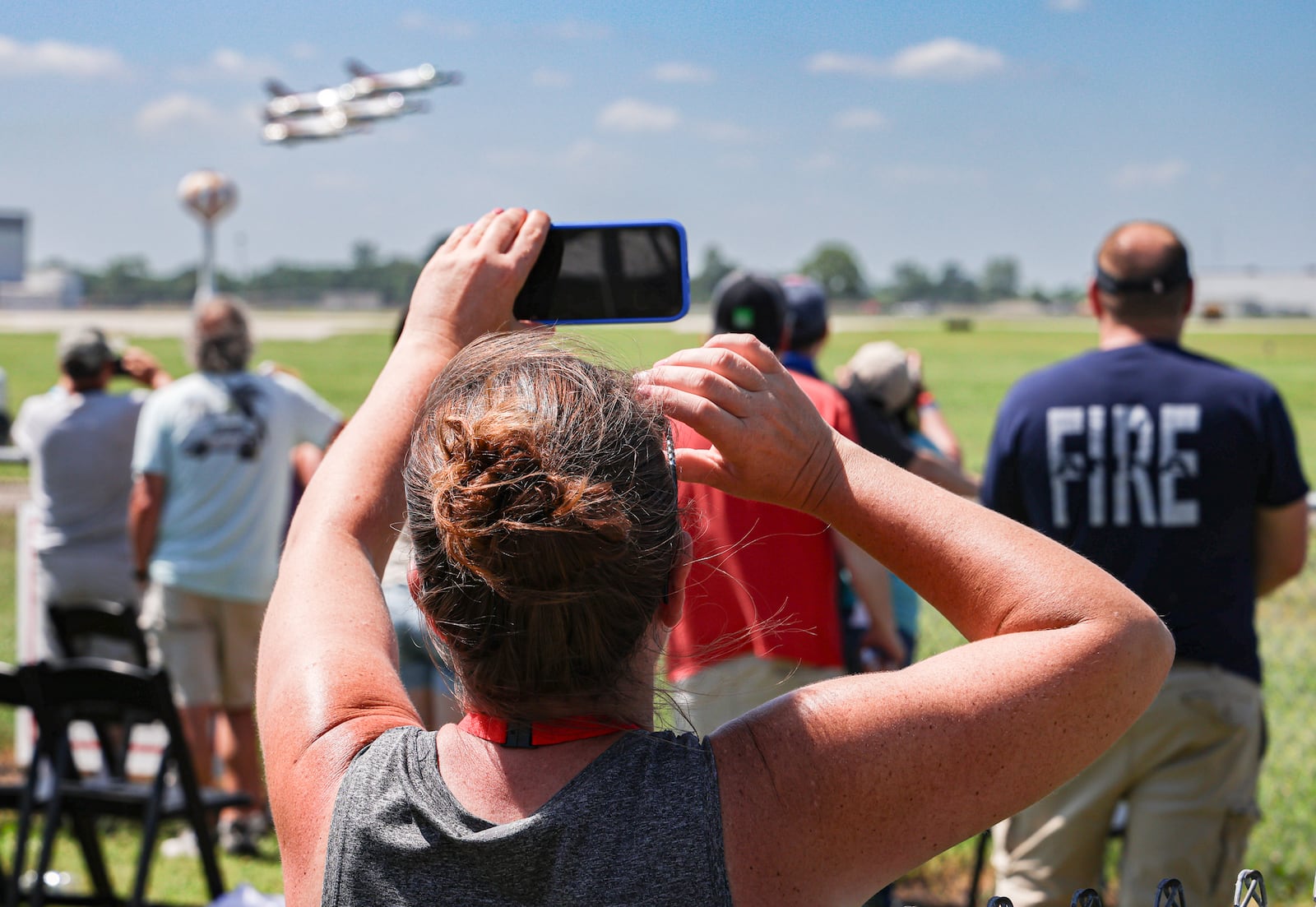 A spectator films the Thunderbirds during the CenterPoint Energy Dayton Air Show June 22. BRYANT BILLING / STAFF