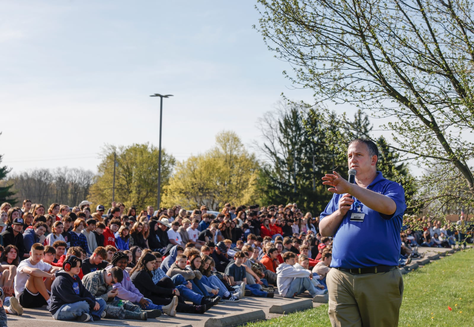 Michael Moyer, flight nurse of Careflight Air & Mobile, speaks to teenagers during a mock crash simulation on  Wednesday, April 23, 2025, at Tecumseh High School. The simulation was held to help prevent impaired and distracted driving. JOSEPH COOKE/STAFF
