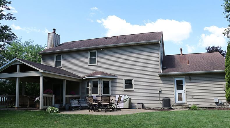 Sliding patio doors open off the great room to a composite deck, paver-brick patio and deep back yard.