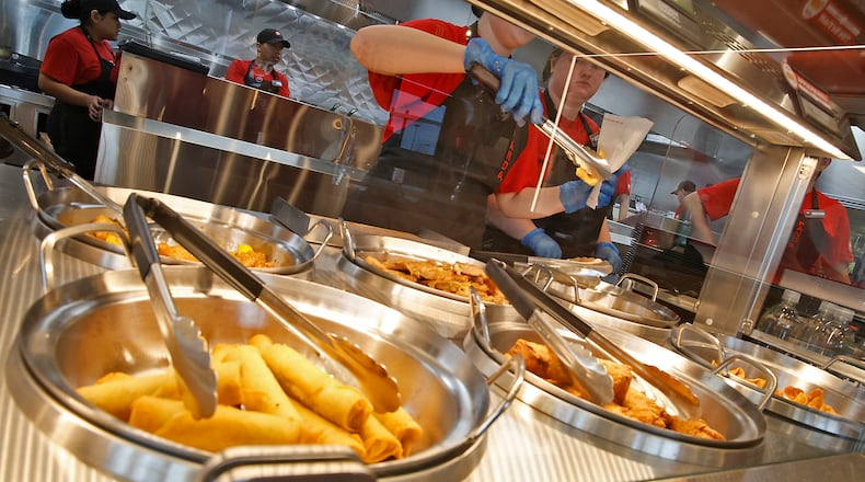 Panda Express has a fifth location planned for the Miami Valley, this time at the Mall at Fairfield Commons in Beavercreek. In this file photo, employees at the Springfield Panda Express serve customers on its opening day, Oct. 25, 2023. BILL LACKEY/STAFF