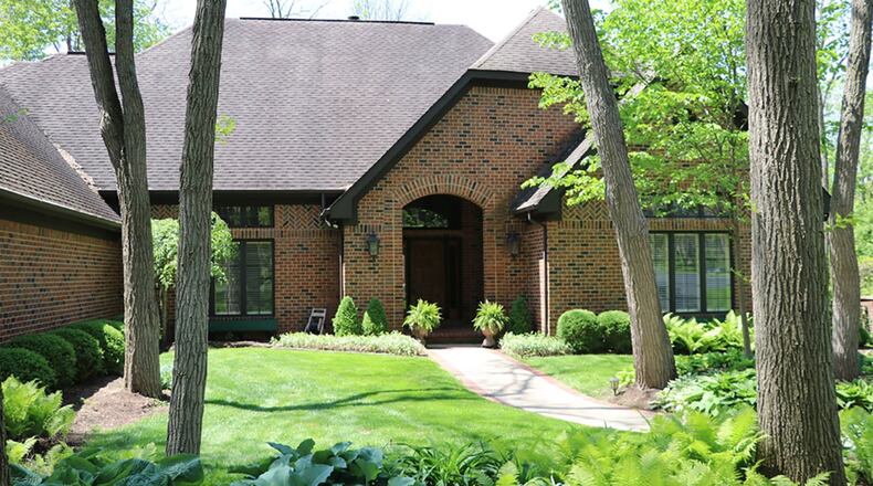 This brick home sits on 1.87-acre wooded lot within a gated community. The lower level of the house has a recreation room, sauna room, bedroom and bathroom. The main level has deck access from both the great room and living room. CONTRIBUTED PHOTOS BY KATHY TYLER