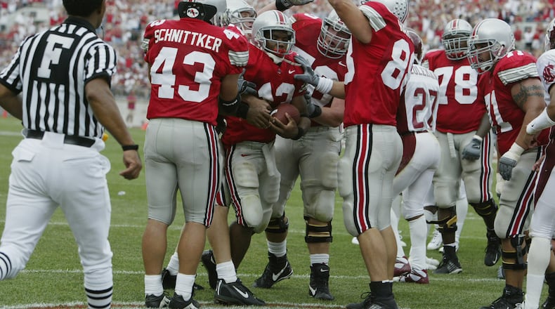 COLUMBUS, OH - SEPTEMBER 14:  Maurice Clarett #13 of Ohio State is congratulated by his teammates after his touchdown during the game against Washington State on September 14, 2002 at Ohio Stadium in Ohio.  Ohio State won the game, 25-7.  (Photo by Tom Pidgeon/Getty Images)