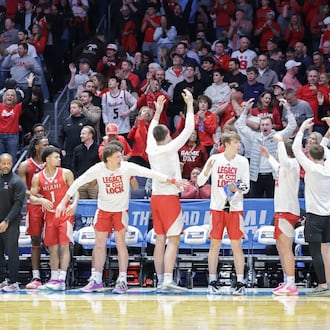 Miami players on the bench celebrate in the final seconds of an 89-79 win over Southern Methodist in an NCAA First Four game on Wednesday, March 18 at University of Dayton Arena. BRYANT BILLING / STAFF