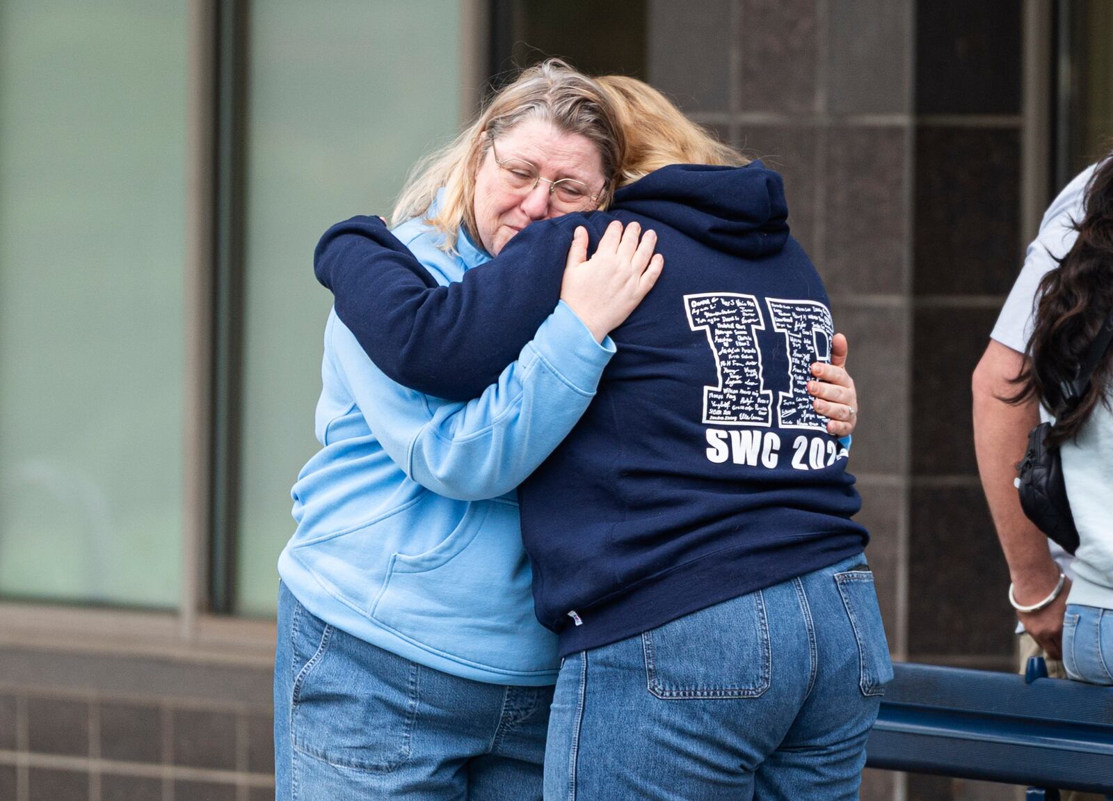 Women console each other after leaving flowers near the site where a vehicle drove into crowd at a Lapu Lapu Day festival in Vancouver, British Columbia, Sunday, April 27, 2025. (Rich Lam/The Canadian Press via AP)