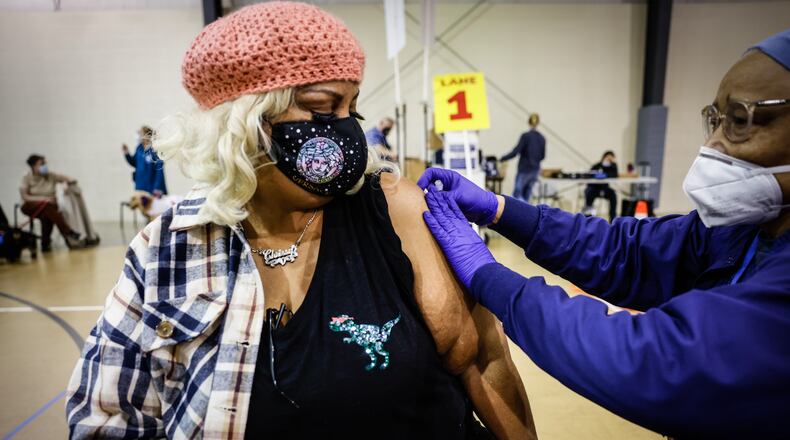 Christina Marshall, from Dayton, gets her COVID-19 booster shot at a Montgomery County Health vaccine clinic at Bethesda Temple Wednesday Feb. 16, 2022. JIM NOELKER/STAFF