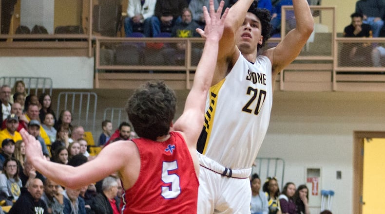 Sidney’s Andre Gordon shoots over Carroll’s Will Severt during Sidney’s 48-35 victory Saturday night in a first-round sectional game at Vandalia-Butler. Gordon scored 19 of his 30 points in the second half. Jeff Gilbert/CONTRIBUTED