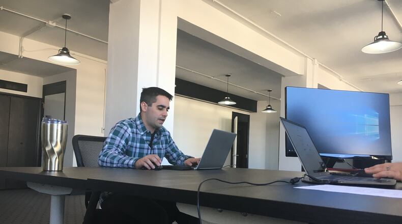 Ryan Baker is one of the owners of Upsourced Accounting. The company was one of the first three tenants of the Activated Office program through Downtown Dayton Partnership in Liberty Tower. STAFF PHOTO / HOLLY SHIVELY