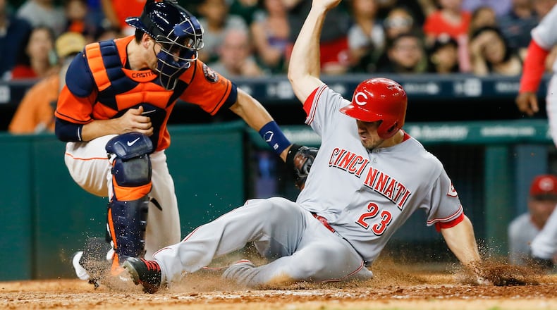 HOUSTON, TX - JUNE 17:  Adam Duvall #23 of the Cincinnati Reds scores on a double by Eugenio Suarez in the eleventh inning as Jason Castro #15 of the Houston Astros is late with the tag  at Minute Maid Park on June 17, 2016 in Houston, Texas.  (Photo by Bob Levey/Getty Images)