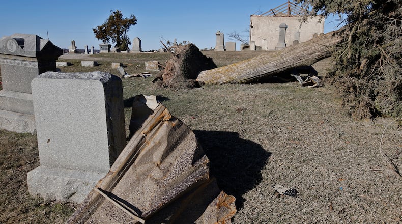 Grave markers and trees are toppled over in the Fletcher-Chapel Cemetery after Wednesday's tornado. BILL LACKEY/STAFF