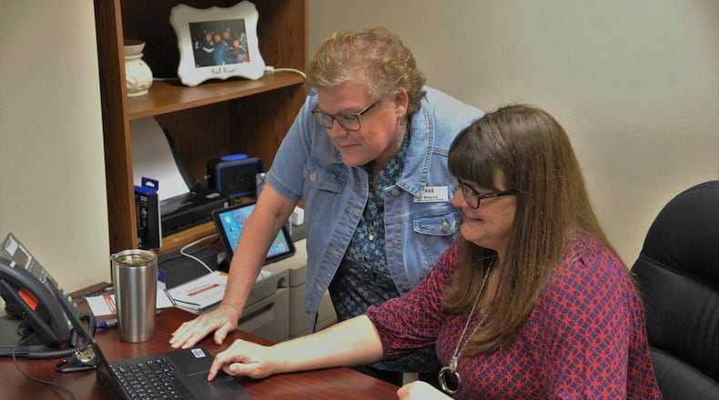 Dawn Ivy (left) and Kathy Hobbs review a financial spreadsheet May 3, making sure everything is within budget at the Airman and Family Readiness Center at Wright-Patterson Air Force Base. AFRC finance classes and counseling are available to help Airmen and their families learn how to better balance their finances or pay off debts earlier. (U.S. Air Force photo/Loren Deer)