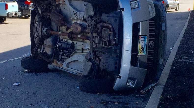 A vehicle overturned after failing to stop in the Walmart parking lot in Greenville and clipping another car. STEVE BAKER/STAFF