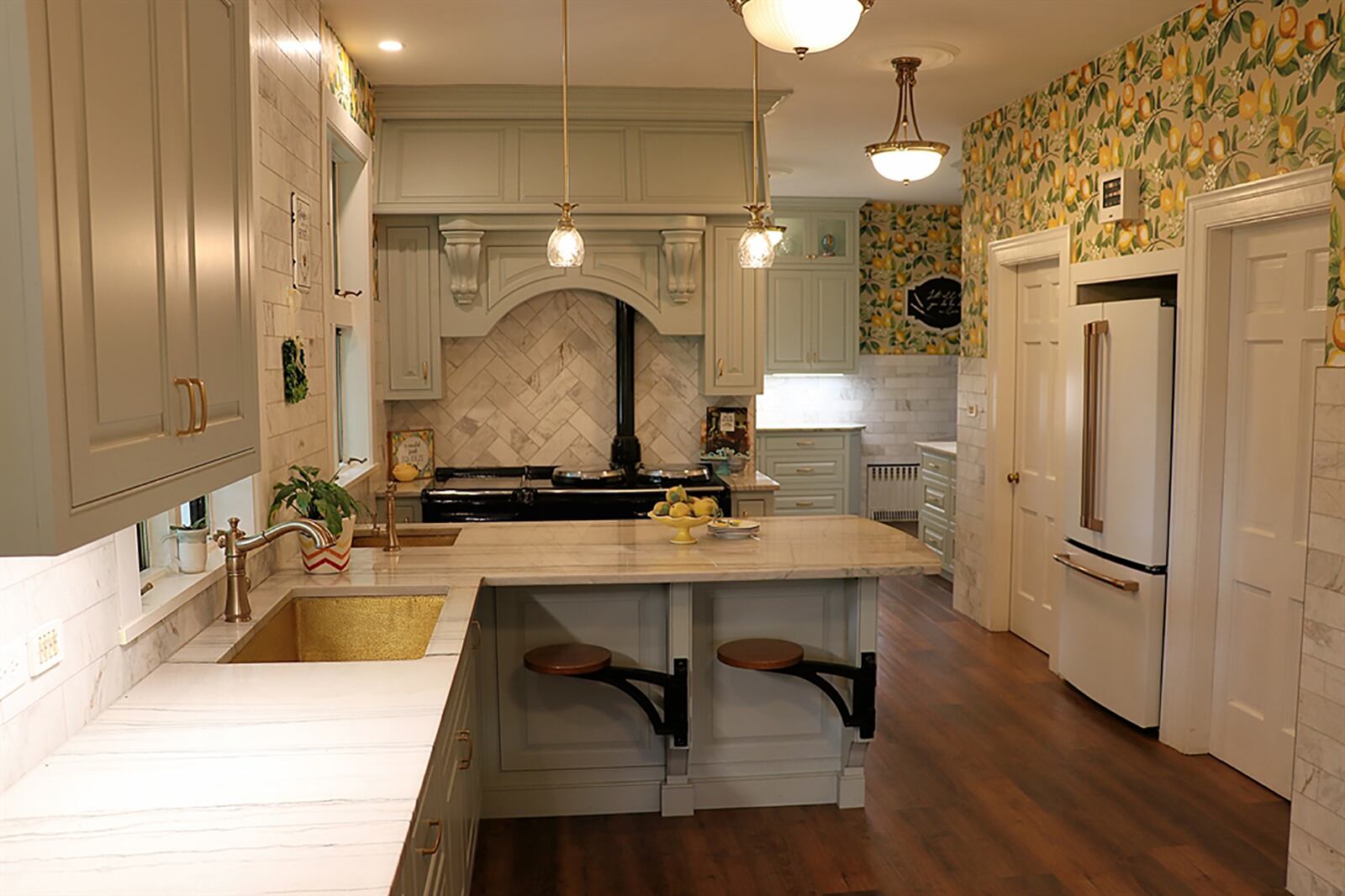 Stretching the length of the west-side, the kitchen features three working stations with two farm sinks and a preparation sink. There is a retractable breakfast table and two swinging bar stools. Three refrigerator nooks have updated GE refrigerators. CONTRIBUTED PHOTO BY KATHY TYLER