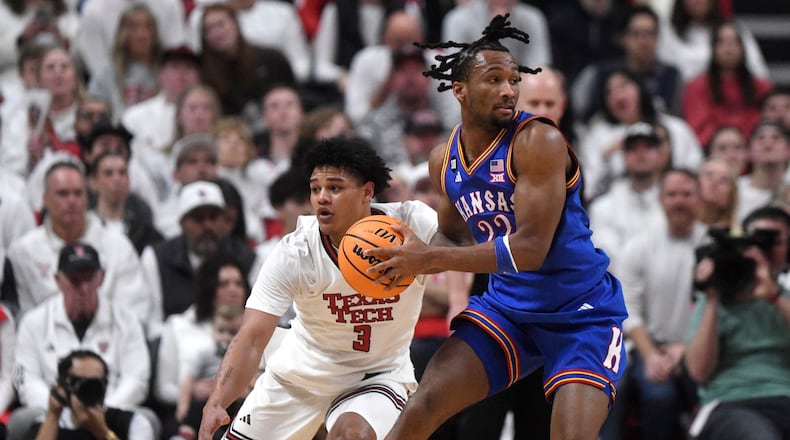 Texas Tech forward Lejuan Watts (3) attempts to guard Kansas guard Darryn Peterson (22) during the first half of an NCAA college basketball game, Monday, Feb. 2, 2026, in Lubbock, Texas. (AP Photo/Annie Rice)