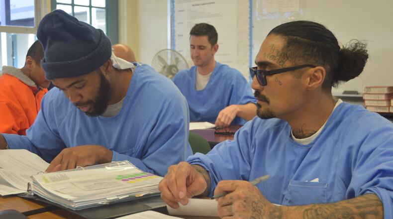 Students at Tehachapi prison work to create oral reports on how various communities in California enforce the "three strikes" law.