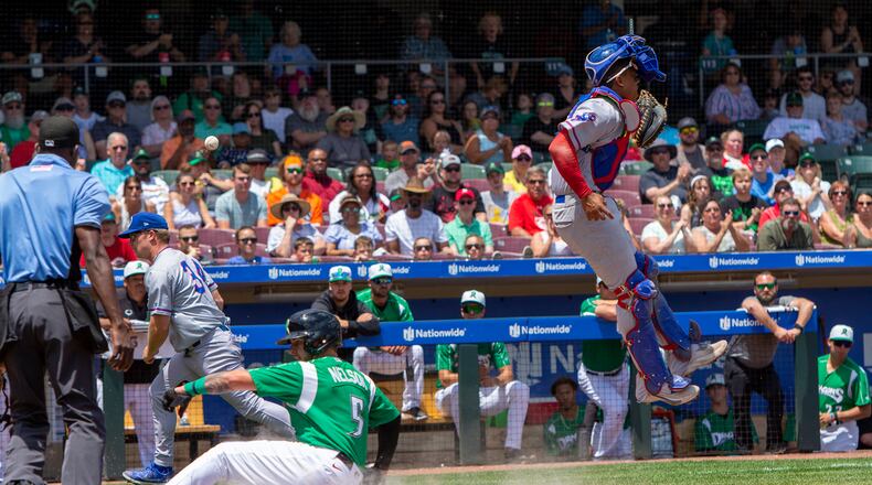 The Dragons' Mat Nelson scores on an overthrow during the Dragons five-run third inning in Sunday's game against South Bend at Day Air Ballpark.