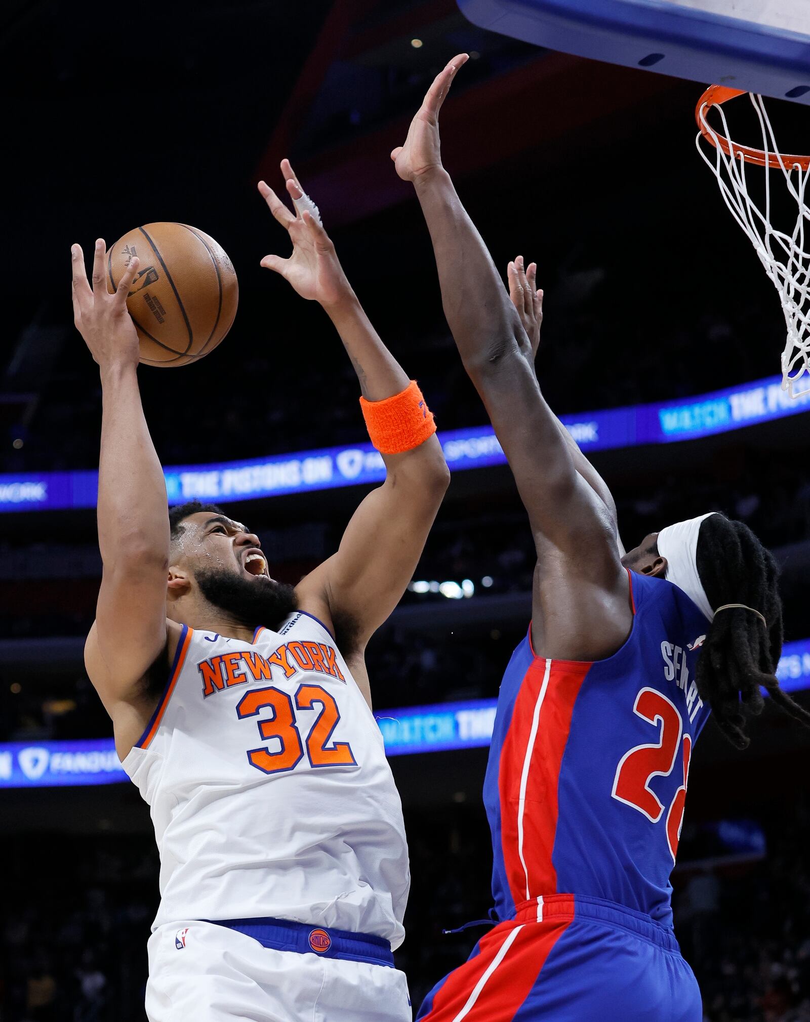 New York Knicks center Karl-Anthony Towns (32) goes to the basket against Detroit Pistons center Isaiah Stewart, right, during the first half of an NBA basketball game Thursday, April 10, 2025, in Detroit. (AP Photo/Duane Burleson)