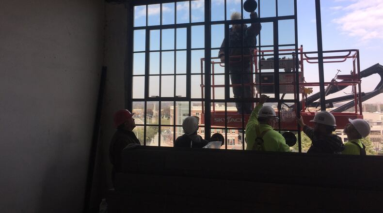 Crews install windows at the former Delco building, which is being converted into lofts and restaurant space. MIKE HOYING /BRACKETT BUILDERS