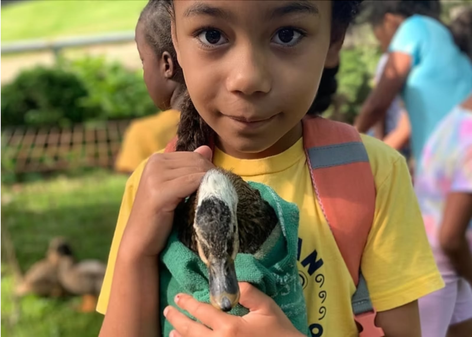 A child holds a duck at The Dayton Urban Riding Center. “The ducks are a gateway to the kids feeling comfortable around the horses," said co-owner Charity Goode. CONTRIBUTED