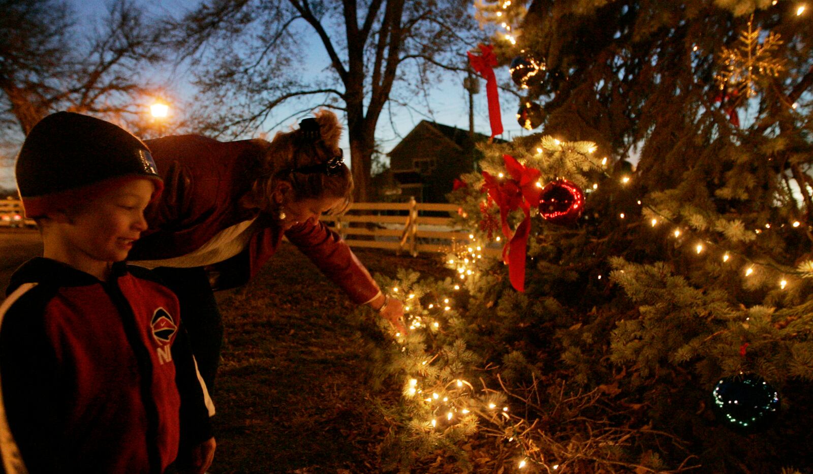 Aiden Brown, 3yrs old, looks over the Christmas tree, in Benham's Grove, with his grandmother, Kelley Brown. They were attending the official Centerville tree lighting in the park.