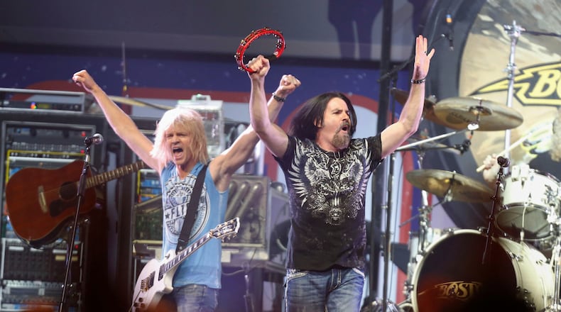 FILE - Tommy DeCarlo, lead singer of the group Boston, right, performs at the Boston Strong Concert: An Evening of Support and Celebration at the TD Garden, Thursday, May 30, 2013, in Boston. (Photo by Bizuayehu Tesfaye/Invision/AP, File)