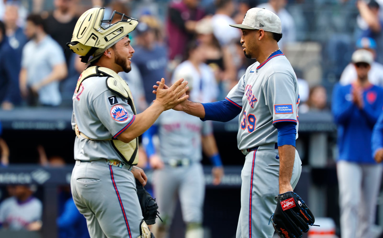 New York Mets catcher Luis Torrens (13) and pitcher Edwin Díaz (39) celebrate after defeating the New York Yankees following a baseball game, Saturday, May 17, 2025, in New York. (AP Photo/Noah K. Murray)