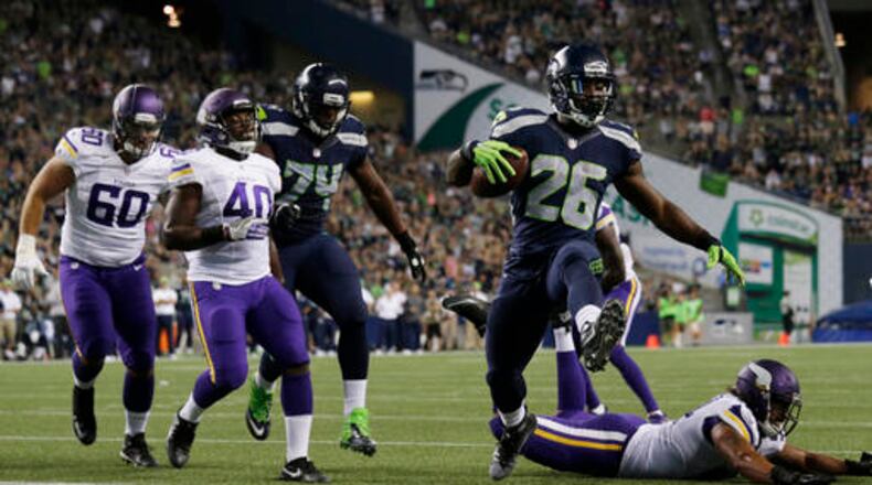 Seattle Seahawks running back Troymaine Pope (26) scores a touchdown against the Minnesota Vikings during the second half of a preseason NFL football game Thursday, Aug. 18, 2016, in Seattle. (AP Photo/John Froschauer)