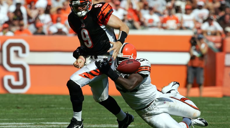 CLEVELAND - SEPTEMBER 11: Carson Palmer #9 of the Cincinnati Bengals fumbles the ball as he is tackled by Chaun Thompson #51of the Cleveland Browns during the third quarter at Cleveland Browns Stadium on September 11, 2005 in Cleveland, Ohio. The Bengals won 27-17. (Photo by Harry How/Getty Images)